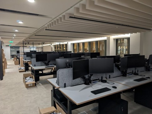 Desks set up with two screens each