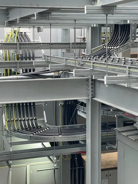 Power cable runs on ladder rack at mezzanine level