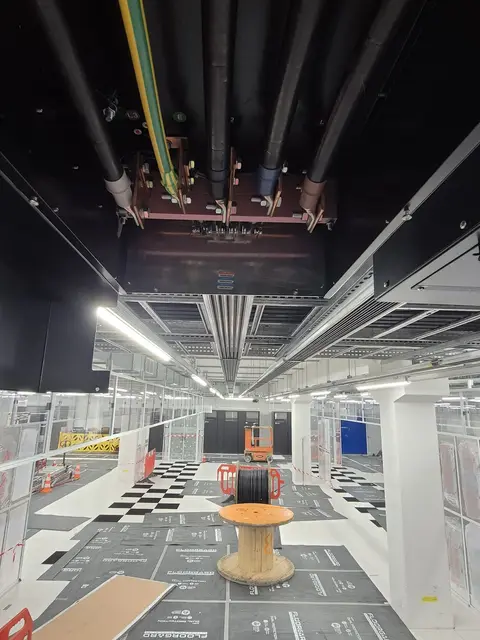 Busbar and cable routes above a chequered floor, with a cable drum
