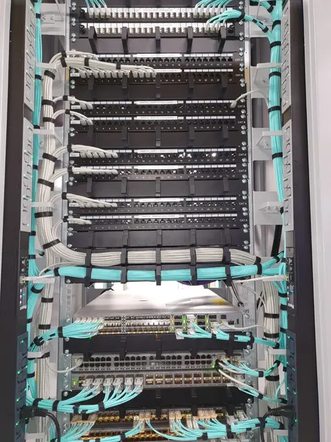 Patch panels with aqua fibre patching in a rack