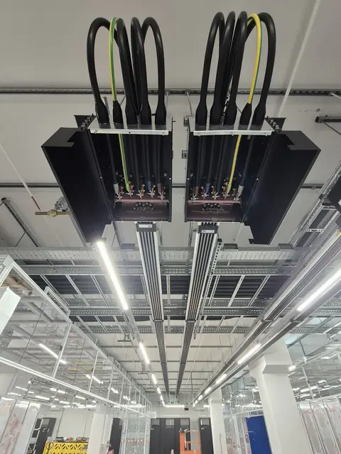 Busbar tap-offs feeding the racks in a white hall
