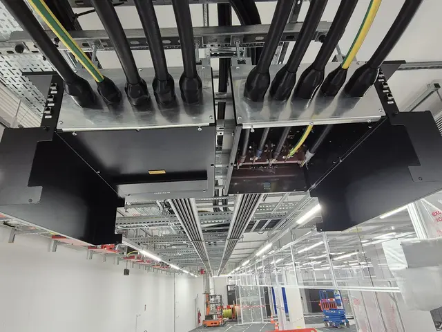 Busbar tap-off units overhead in a dark hall